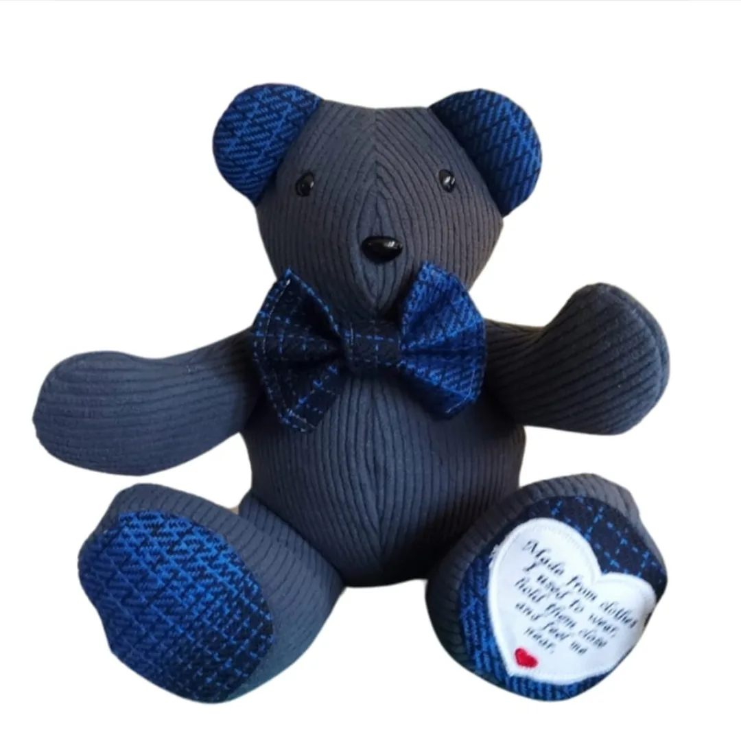 Memory bear made from grey corduroy with blue tweed ears, paw pads and dicky bow, with an embroidered heart poem